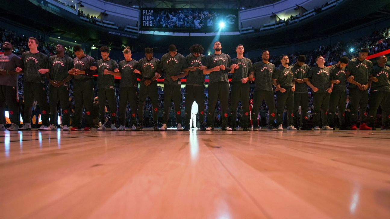 Toronto Raptors interlock arms during national anthems ahead of preseason opener vs. Golden State Warriors