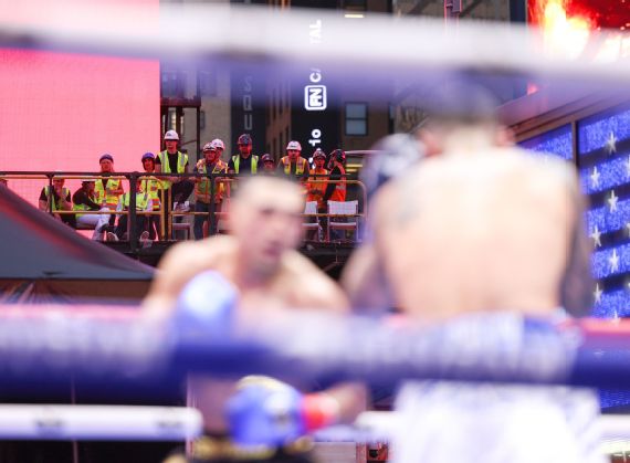 Construction workers watching from a platform