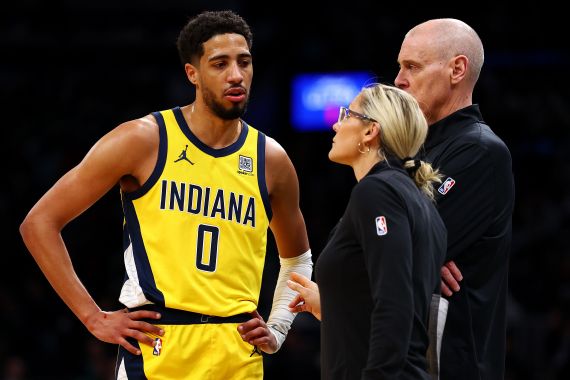 Indiana Pacers coach Rick Carlisle speaks to players on the bench.
