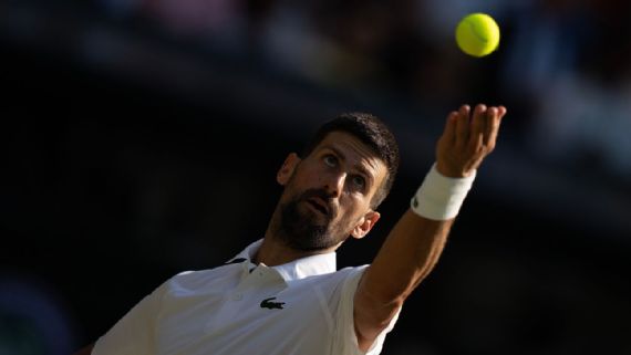 Novak Djokovic playing a volley at Wimbledon