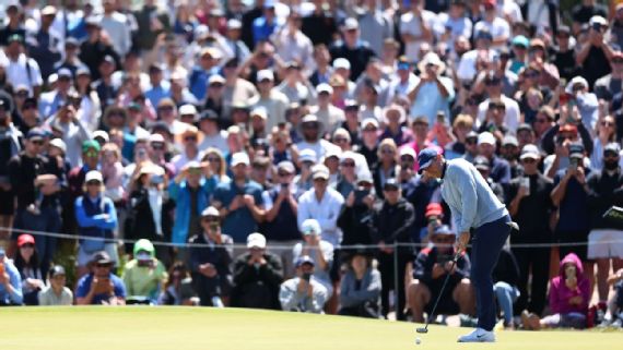 Rory McIlroy putts in front of a huge crowd at Royal Melbourne