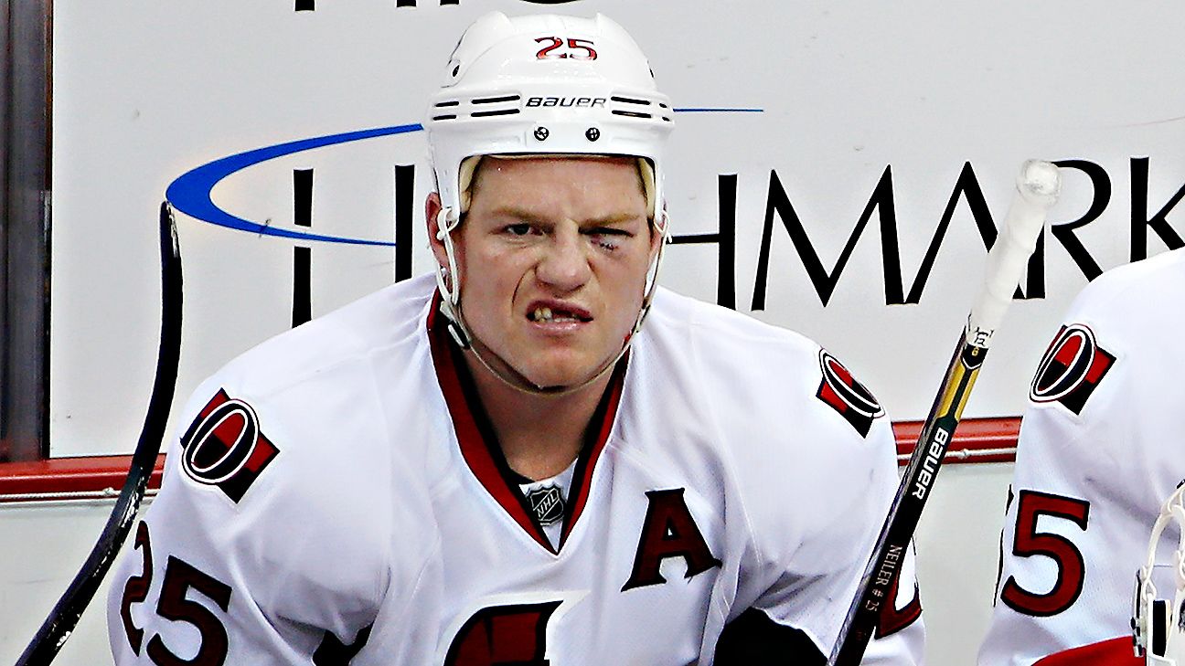 Former Ottawa Senators player Chris Neil and his family watch as a