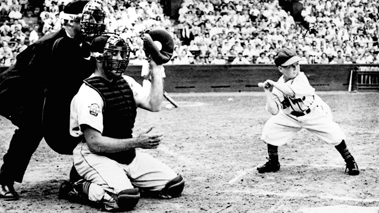 1952: St Louis Browns pitcher, Satchel Paige chats with teammates