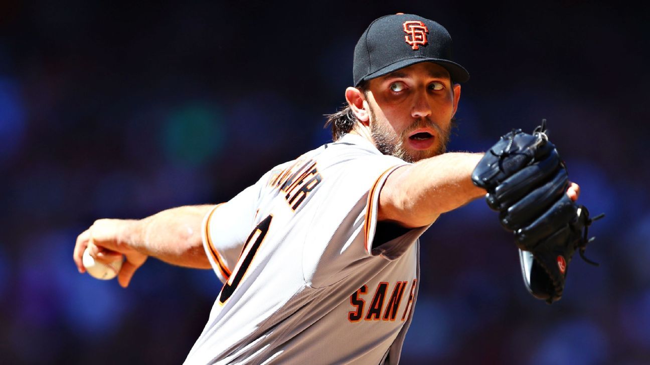 San Francisco Giants starting pitcher Madison Bumgarner touches his beard  as he walks back to the mound while working against the San Diego Padres  during the third inning of a baseball game
