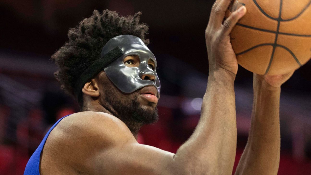 Joel Embiid of Philadelphia 76ers wears full mask courtside, goes