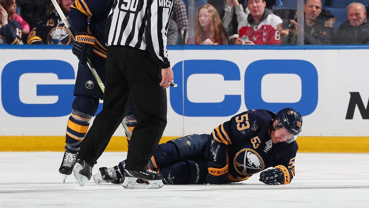 Jeff Skinner of Buffalo Sabres helped off ice after left leg injury