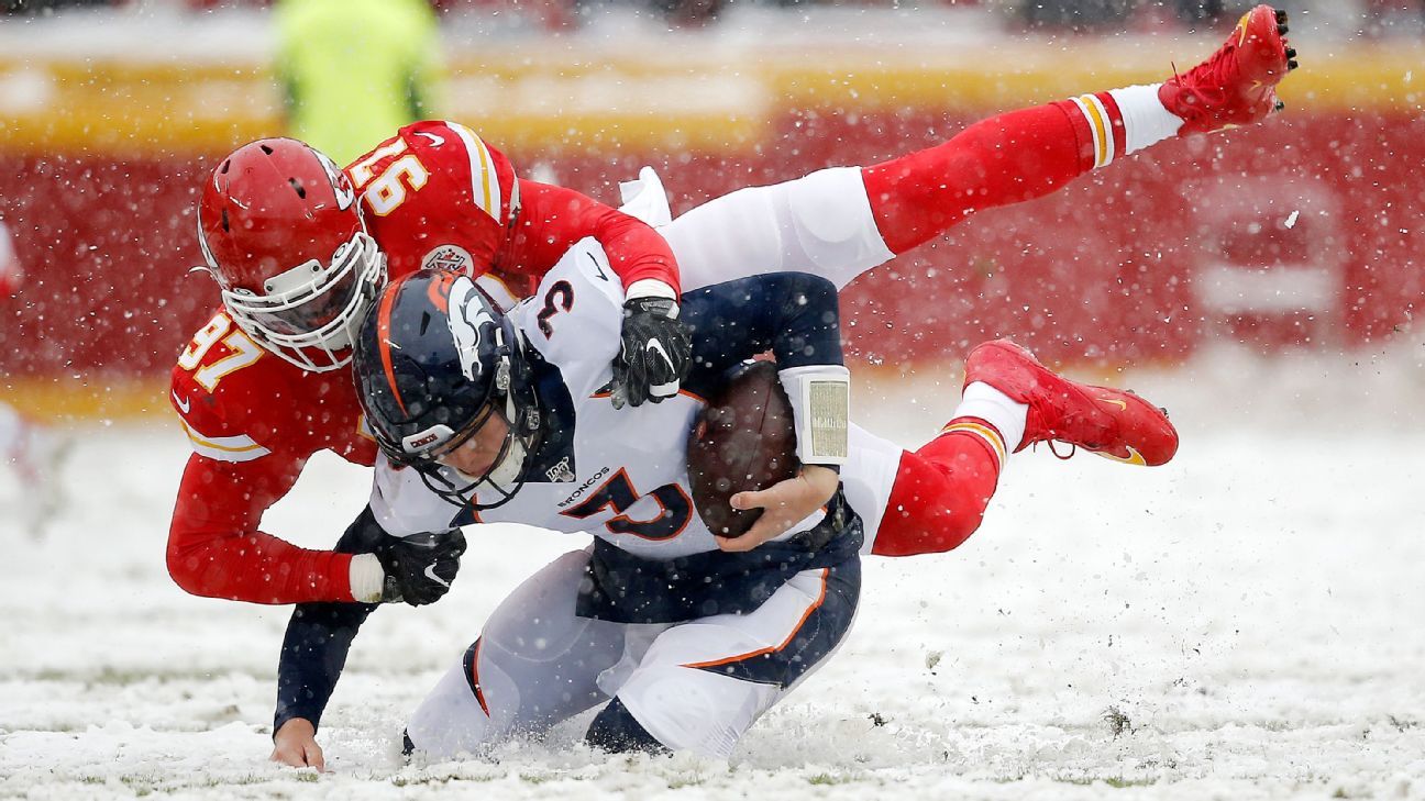 Denver Broncos quarterback Peyton Manning tries to put his jersey back on  his shoulder pads during an NFL football game between the Denver Broncos  and the Kansas City Chiefs, Sunday, Nov. 15