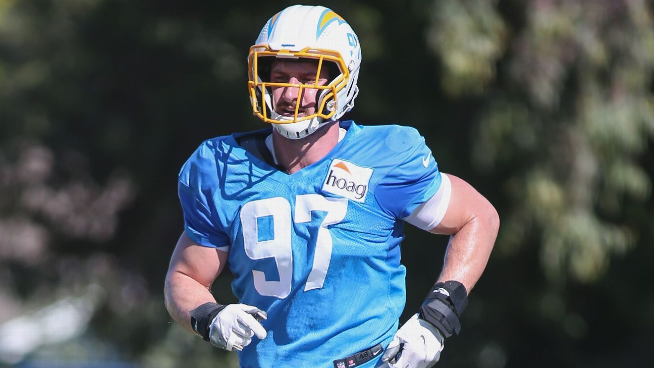 Los Angeles Chargers offensive tackle Rashawn Slater, left, works