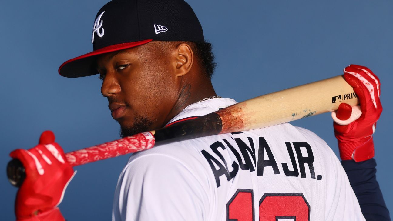 Atlanta Braves outfielder Ronald Acuña Jr. confronted by two fans