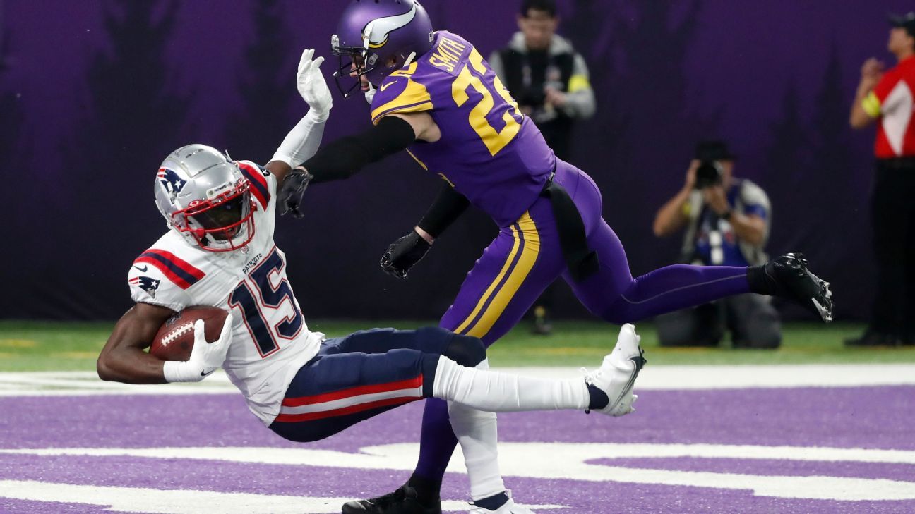 New England Patriots wide receiver Nelson Agholor, left, takes a hand off  from quarterback Mac Jones during the first half of an NFL football game  against the Buffalo Bills in Orchard Park