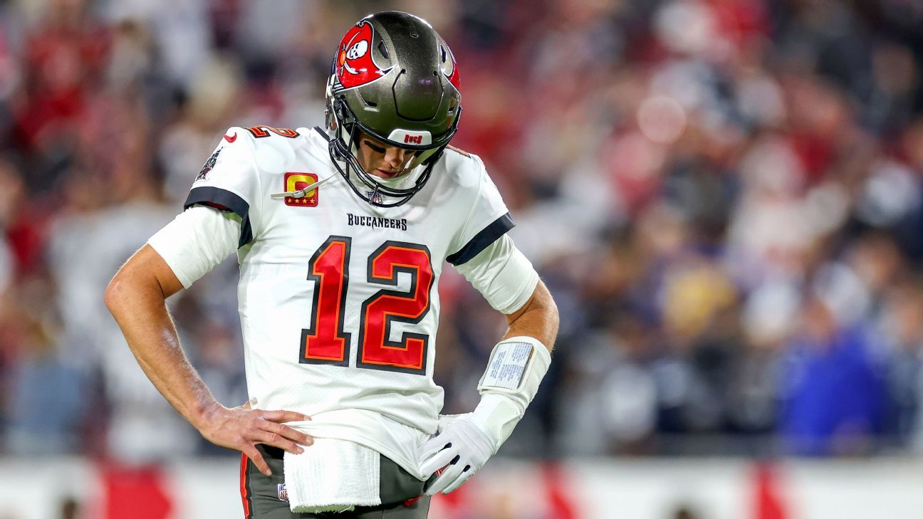 Bucs QB Tom Brady stands in defeat after losing playoff game