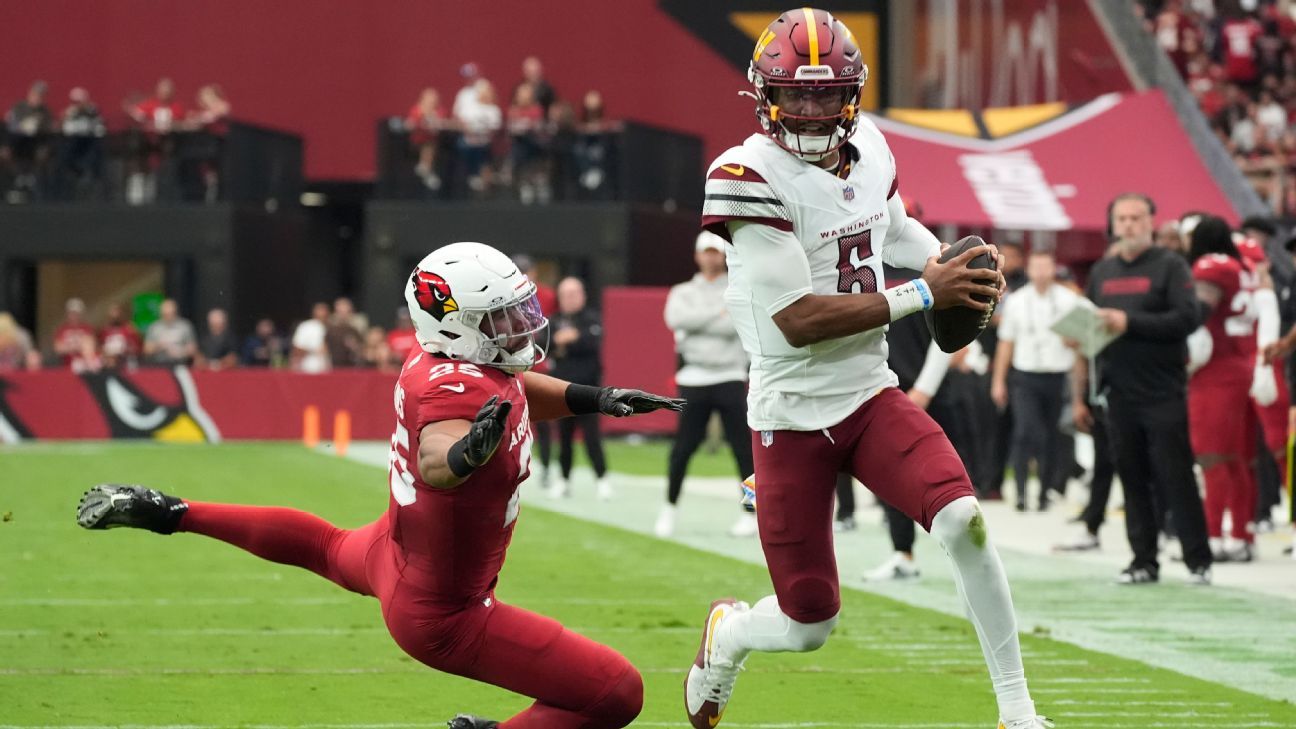 Commanders QB Jayden Daniels weaves through the Cardinals for a 9-yard TD run