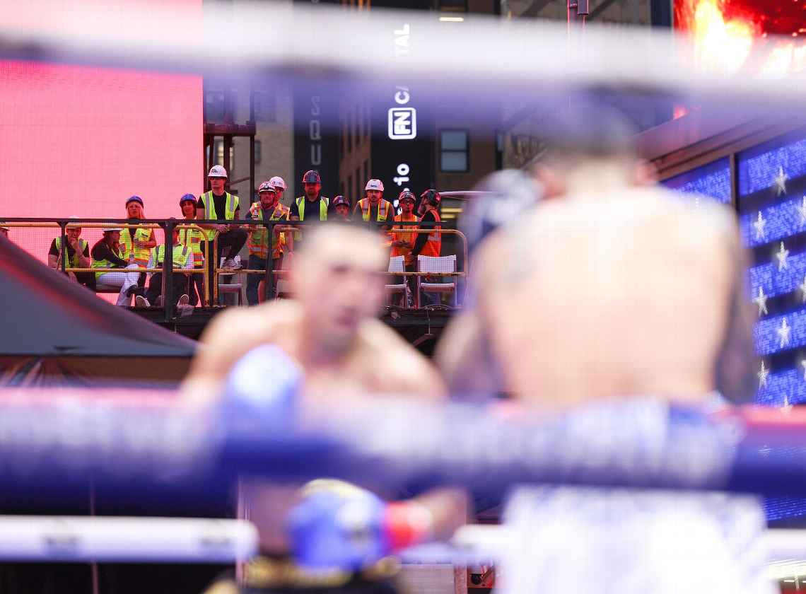 Construction workers watching boxing in Times Square