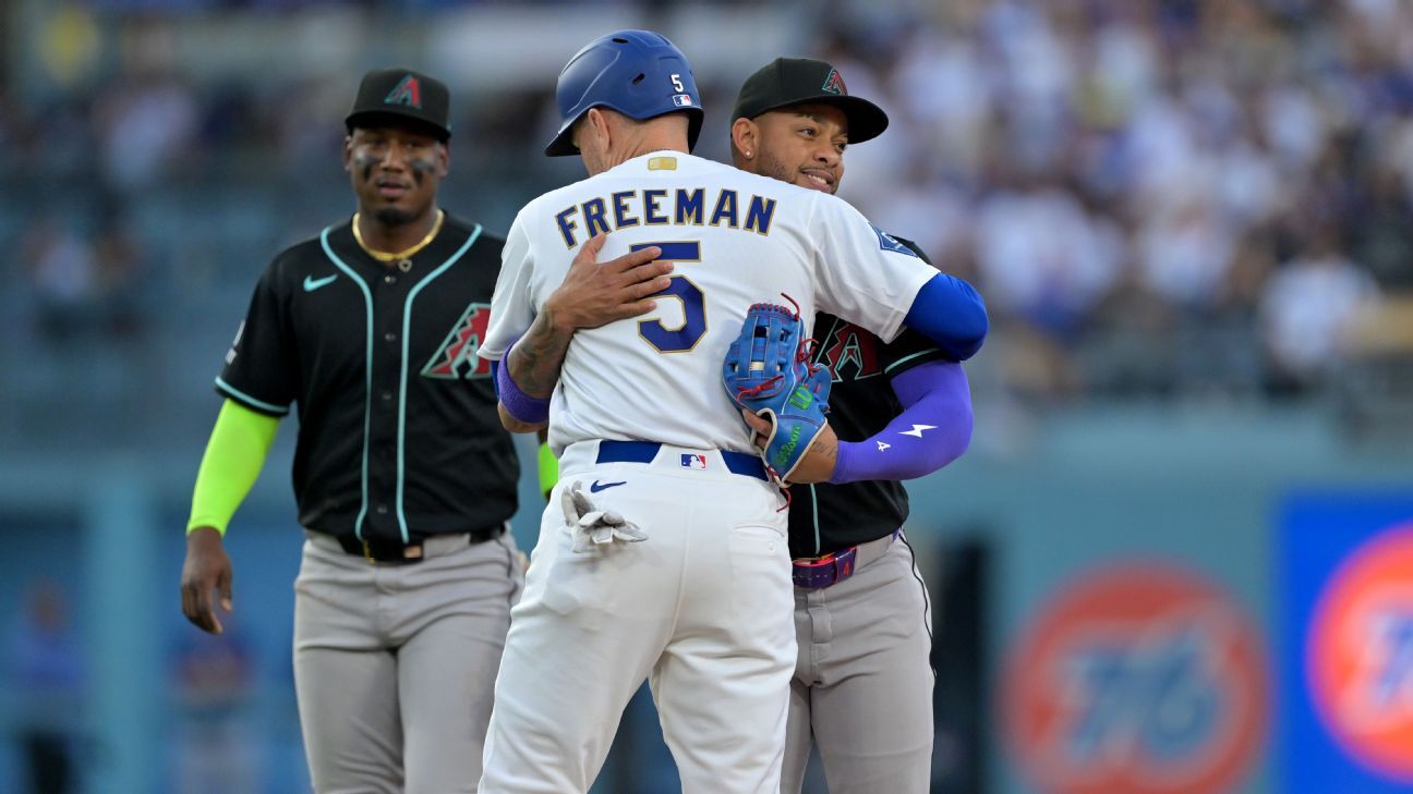 Easily out, Dodgers' Freeman tagged out with hug